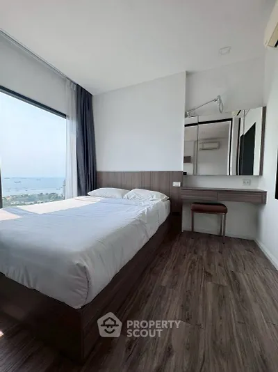 Modern bedroom with stunning sea view and sleek wooden flooring