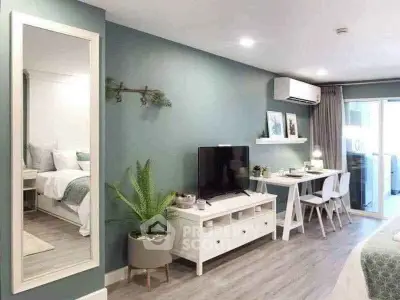 Modern living room with stylish decor, TV unit, and workspace in open layout apartment.