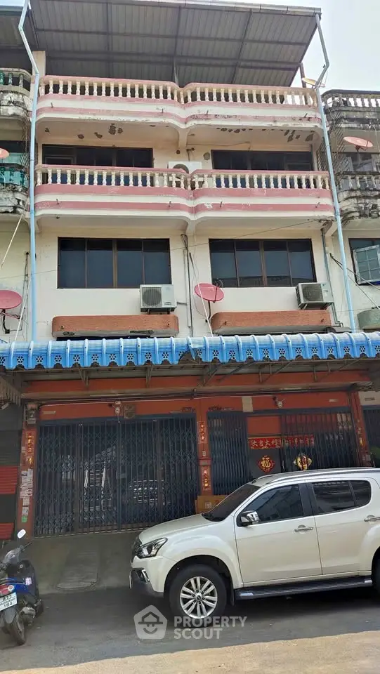Charming multi-story building with unique facade and street-level commercial space.