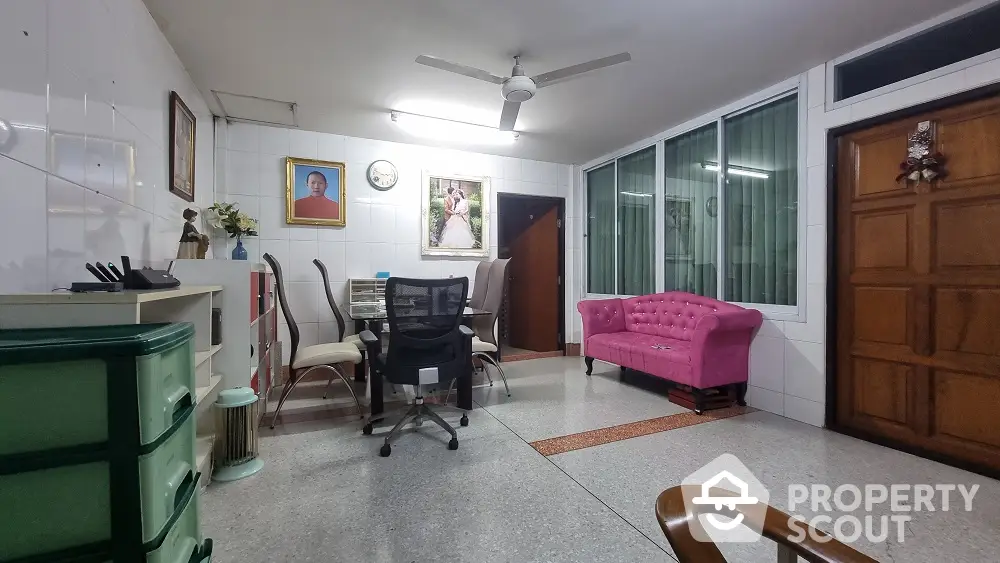 Spacious living room with marble flooring, large windows, and comfortable seating, ideal for family gatherings and relaxation.