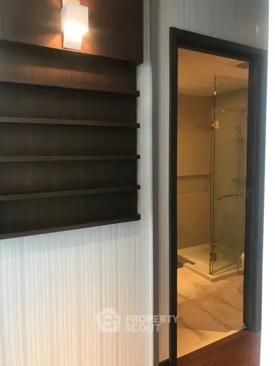 Modern interior with stylish shelving and glimpse of a sleek bathroom
