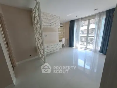 Spacious modern living room with elegant partition and large windows for natural light.