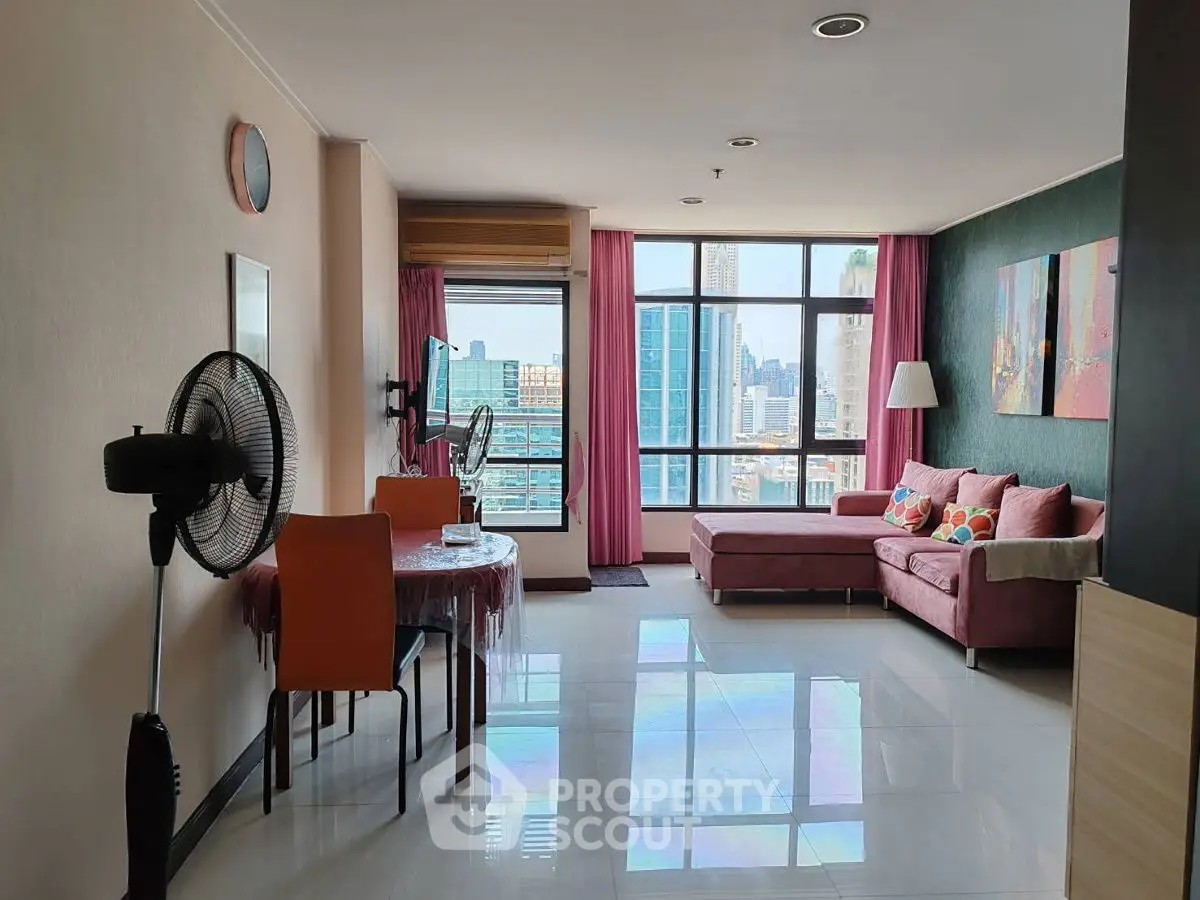 Spacious living room with city view, modern furniture, and vibrant decor