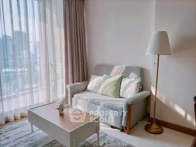 Charming living room with cozy sofa and city view, perfect for relaxation.