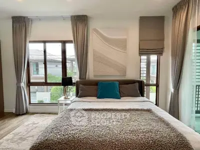 Elegant bedroom with large windows and stylish decor in modern home