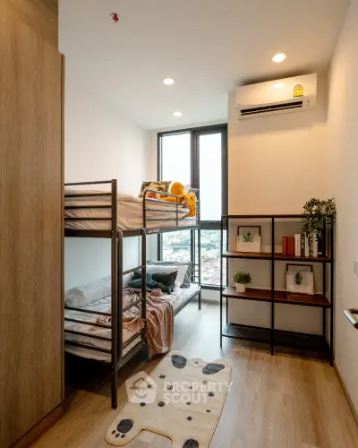 Modern bedroom with bunk beds and city view, ideal for compact living.