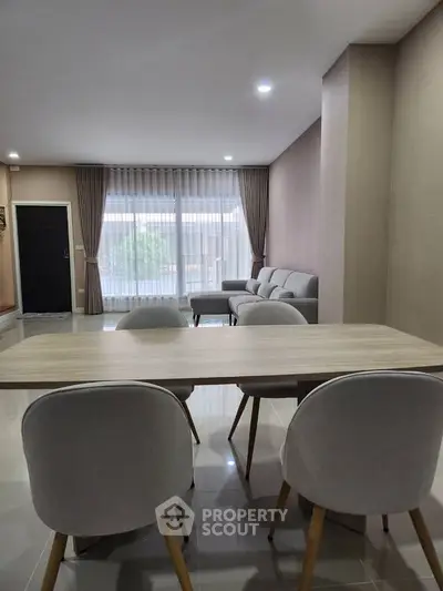 Modern living room with elegant dining area and stylish furniture