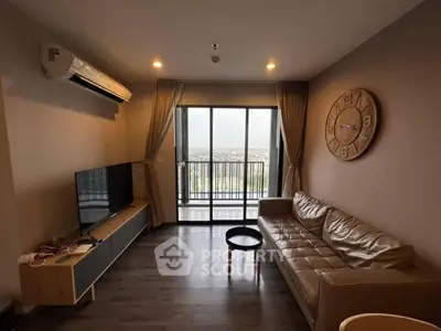 Modern living room with leather sofa, wall clock, and balcony view in a stylish apartment.