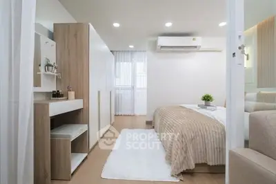 Modern bedroom with stylish decor and ample storage in a cozy apartment.