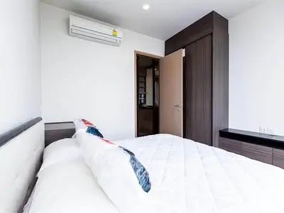 Modern bedroom with sleek design and air conditioning in a stylish apartment.
