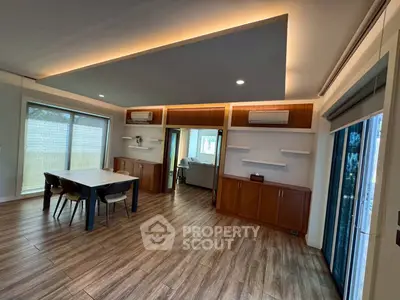 Spacious modern living room with wooden flooring and stylish ceiling lights
