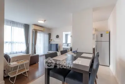 Spacious modern living and dining area with natural light and stylish decor.