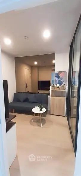 Cozy living room with modern decor and stylish furniture in a compact apartment.