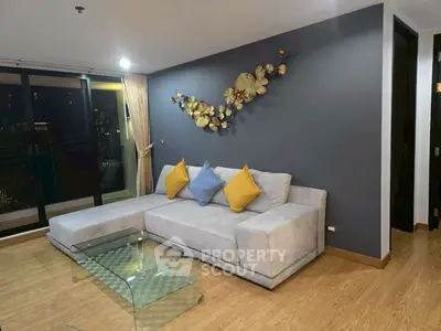 Modern living room with stylish decor and large sofa in a cozy apartment.