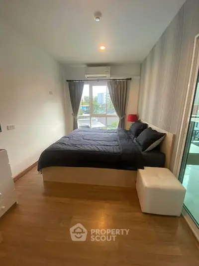 Modern bedroom with large window and stylish decor
