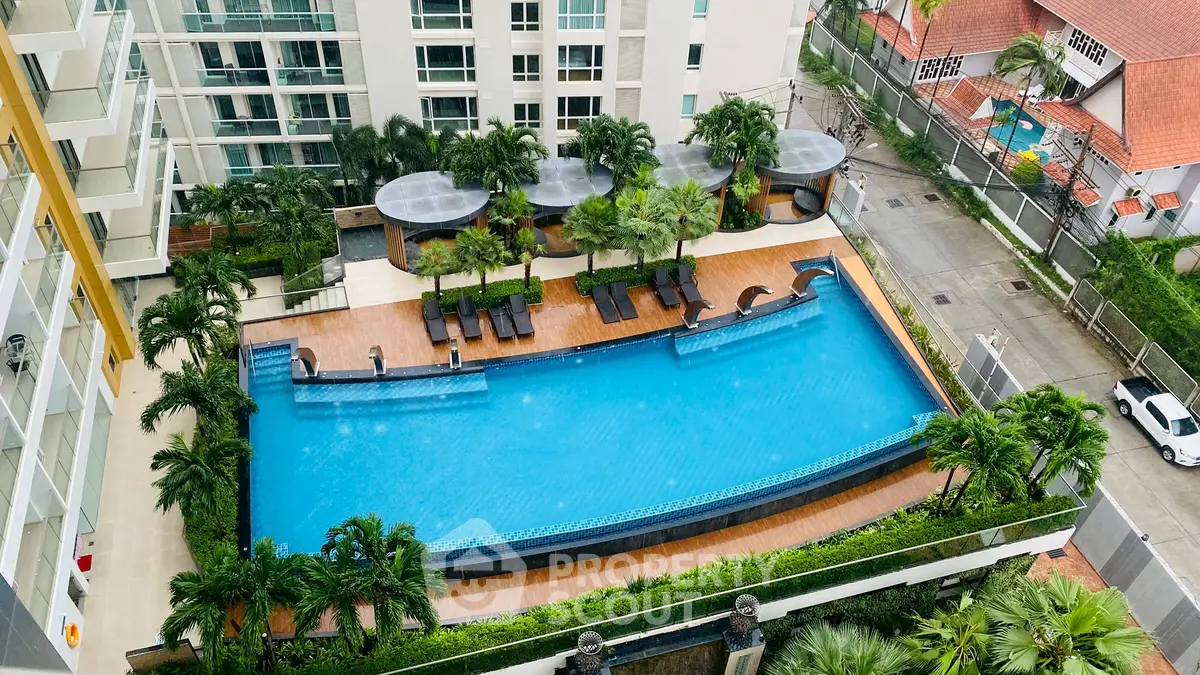 Luxurious apartment complex with stunning pool and lush greenery