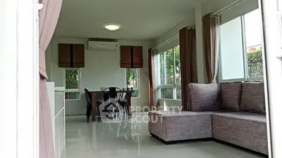 Spacious living room with modern furniture and large windows for natural light.