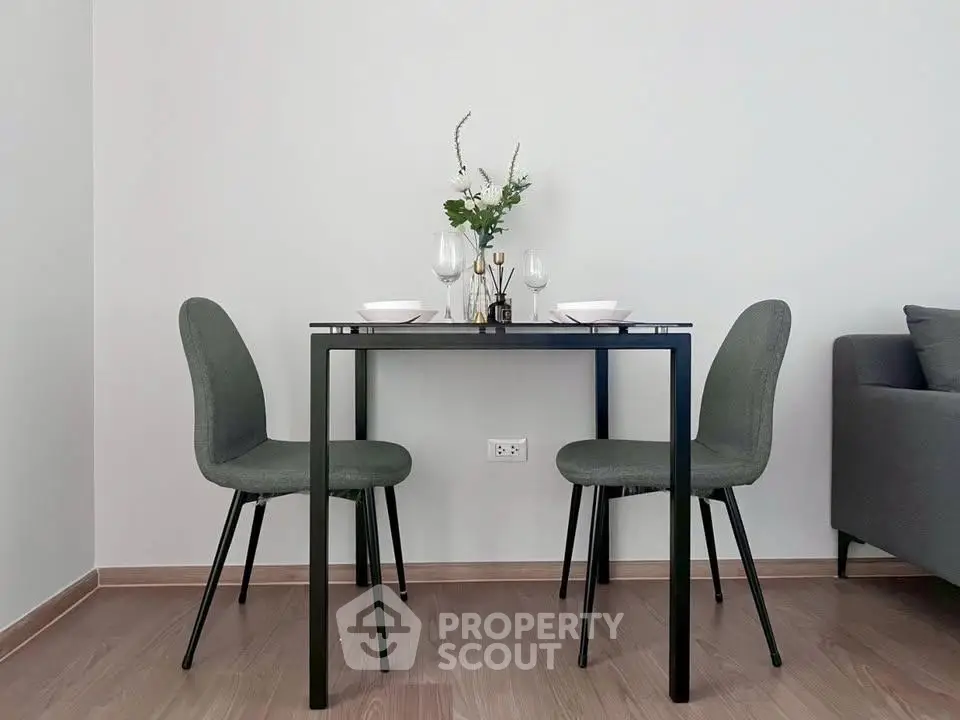 Modern dining area with sleek table and chairs in a minimalist interior setting.
