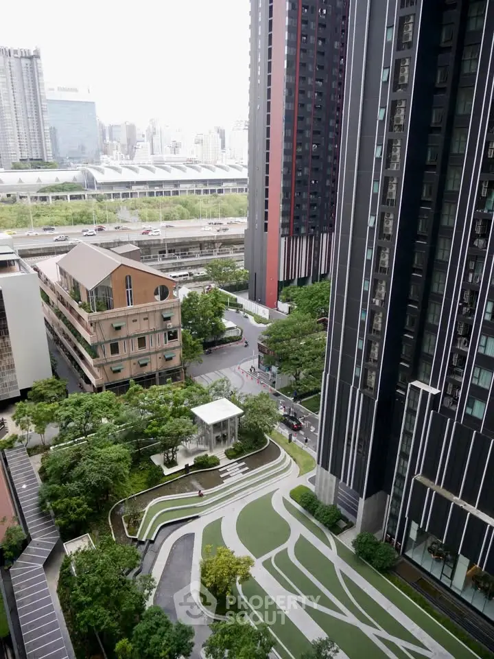 Stunning aerial view of modern high-rise buildings with lush landscaped gardens in urban setting.