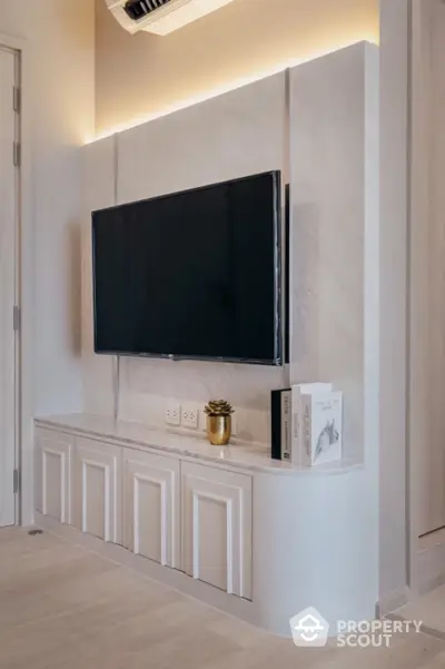 Modern living room with sleek TV setup and elegant cabinetry