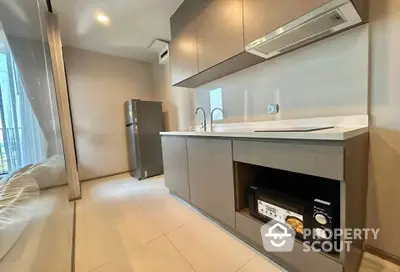 Modern kitchen with sleek cabinetry and built-in appliances in a stylish apartment.