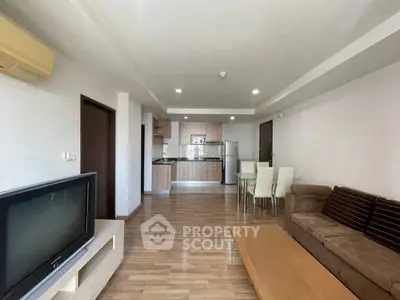 Spacious living room with modern kitchen in open layout apartment