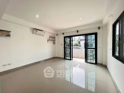 Spacious modern living room with large windows and air conditioning, perfect for comfortable living.