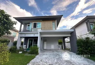 Modern two-story house with spacious driveway and lush green garden