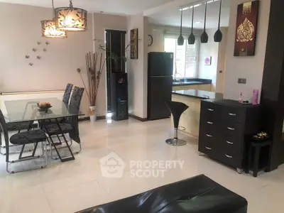 Modern open-plan living and dining area with stylish decor and sleek kitchen.