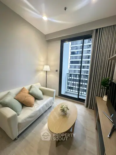 Modern living room with cozy sofa and balcony view in a stylish apartment.