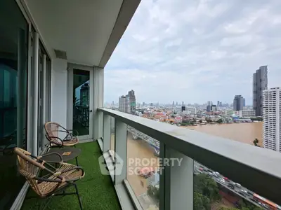 Stunning high-rise balcony with panoramic city and river views, perfect for relaxation.
