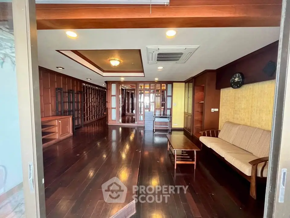 Spacious living room with wooden flooring and elegant furniture