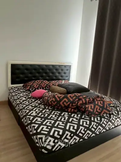 Cozy bedroom with stylish bed and modern decor, perfect for relaxation and comfort.