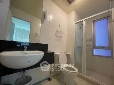 Modern bathroom with sleek fixtures and glass shower enclosure