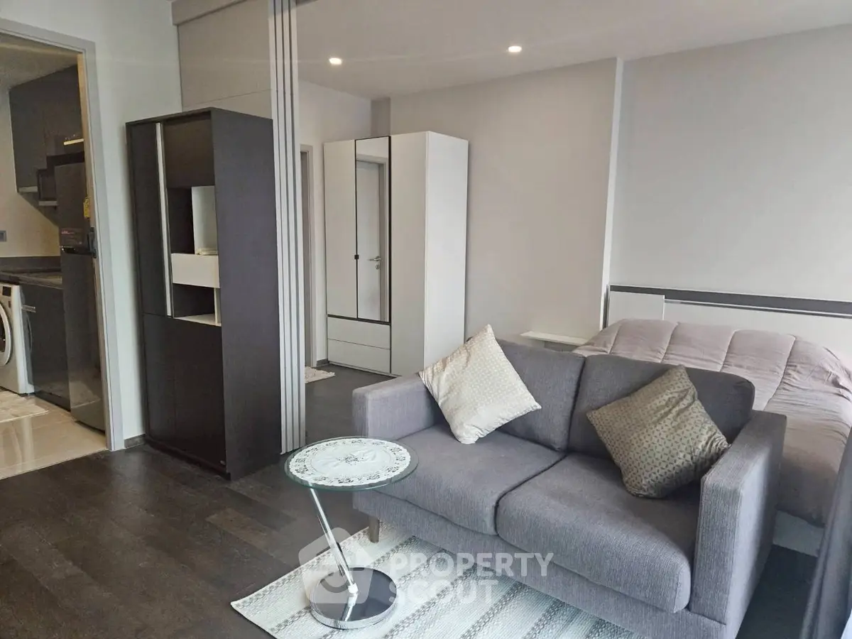 Modern studio apartment with cozy living area and sleek kitchen