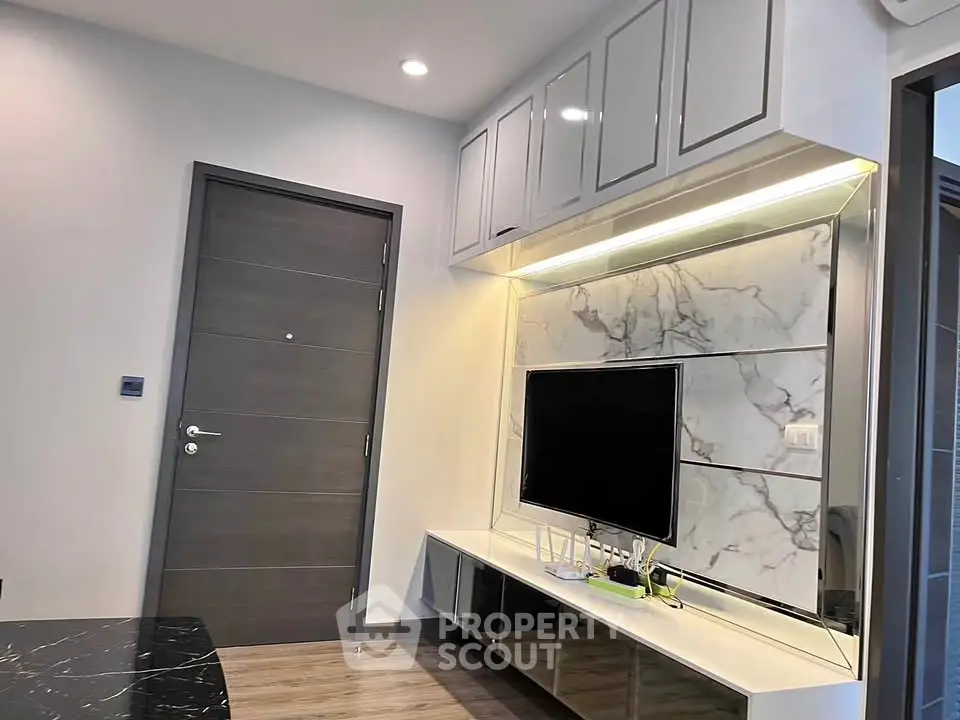 Modern living room with sleek TV unit and marble accent wall