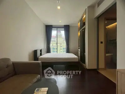 Modern bedroom with large window and cozy seating area