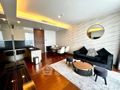 Modern open-plan living room with stylish decor and sleek kitchen area
