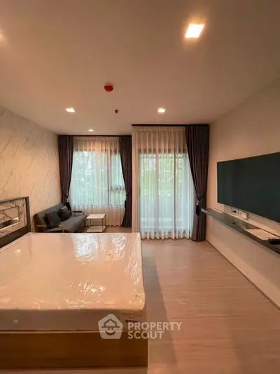 Spacious modern bedroom with large windows and elegant decor