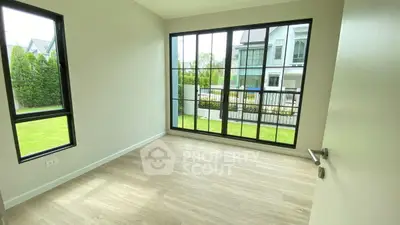 Bright empty room with large windows and garden view in modern home