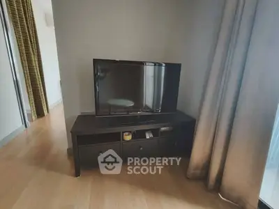 Modern living room with sleek TV setup and elegant curtains