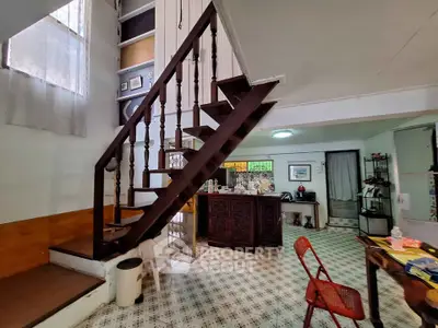 Charming vintage interior with unique staircase and open layout kitchen, perfect for cozy living.