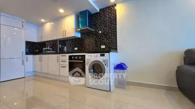 Modern kitchen with sleek black tiles and built-in appliances