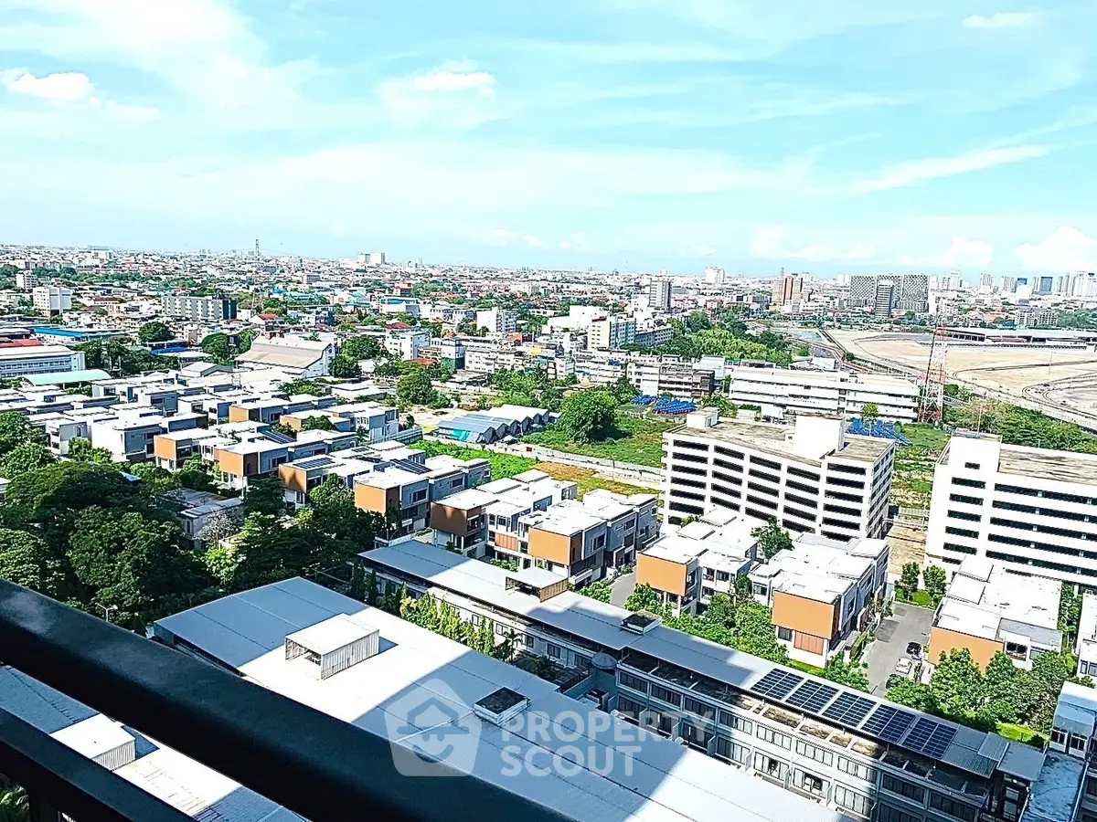 Stunning panoramic city view from high-rise balcony showcasing urban landscape and skyline.