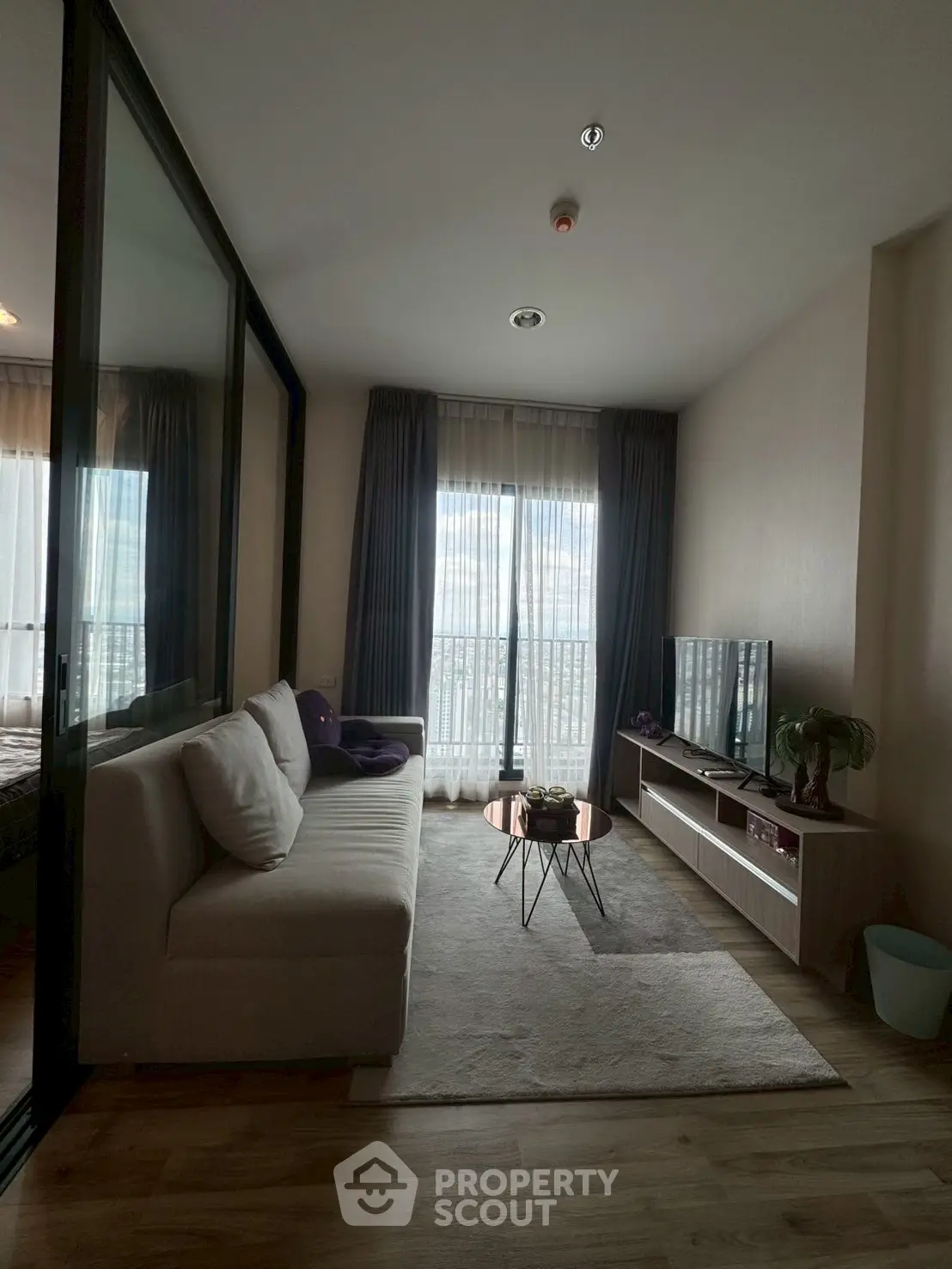Modern living room with cozy sofa and large window view