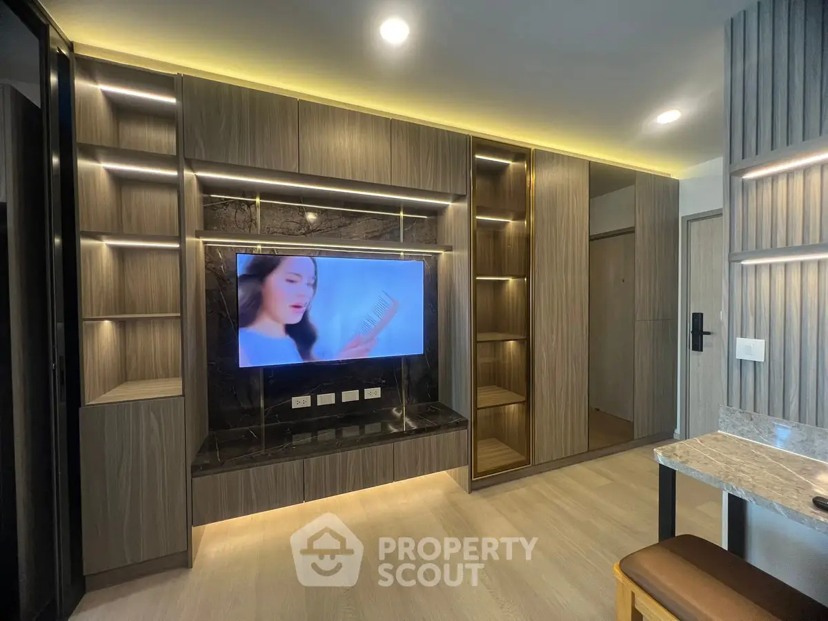 Modern living room with built-in TV unit and elegant lighting
