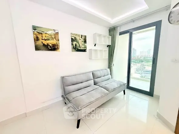 Modern living room with sleek sofa and city view balcony