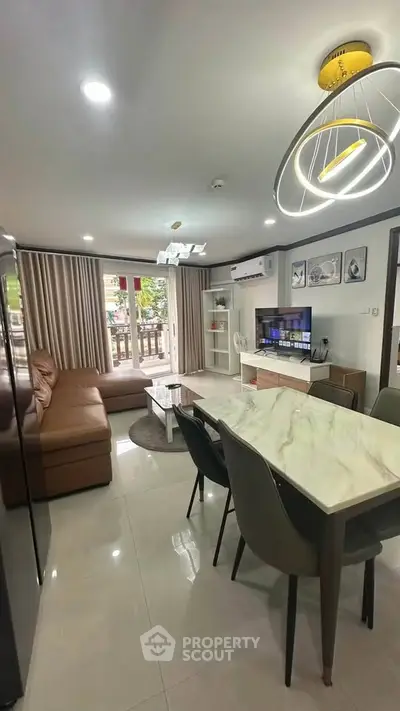 Modern living room with stylish decor, marble dining table, and cozy seating area.