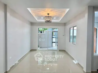 Modern living room with elegant ceiling light and glossy tiled floor