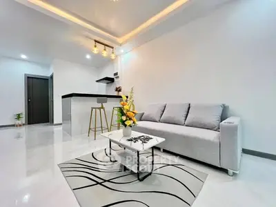 Modern living room with stylish open kitchen and elegant lighting